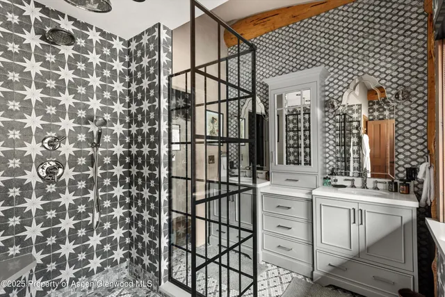 a bathroom with a granite countertop sink and a large mirror