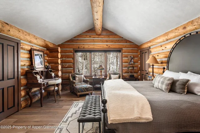 a living room with lots of furniture and a large window