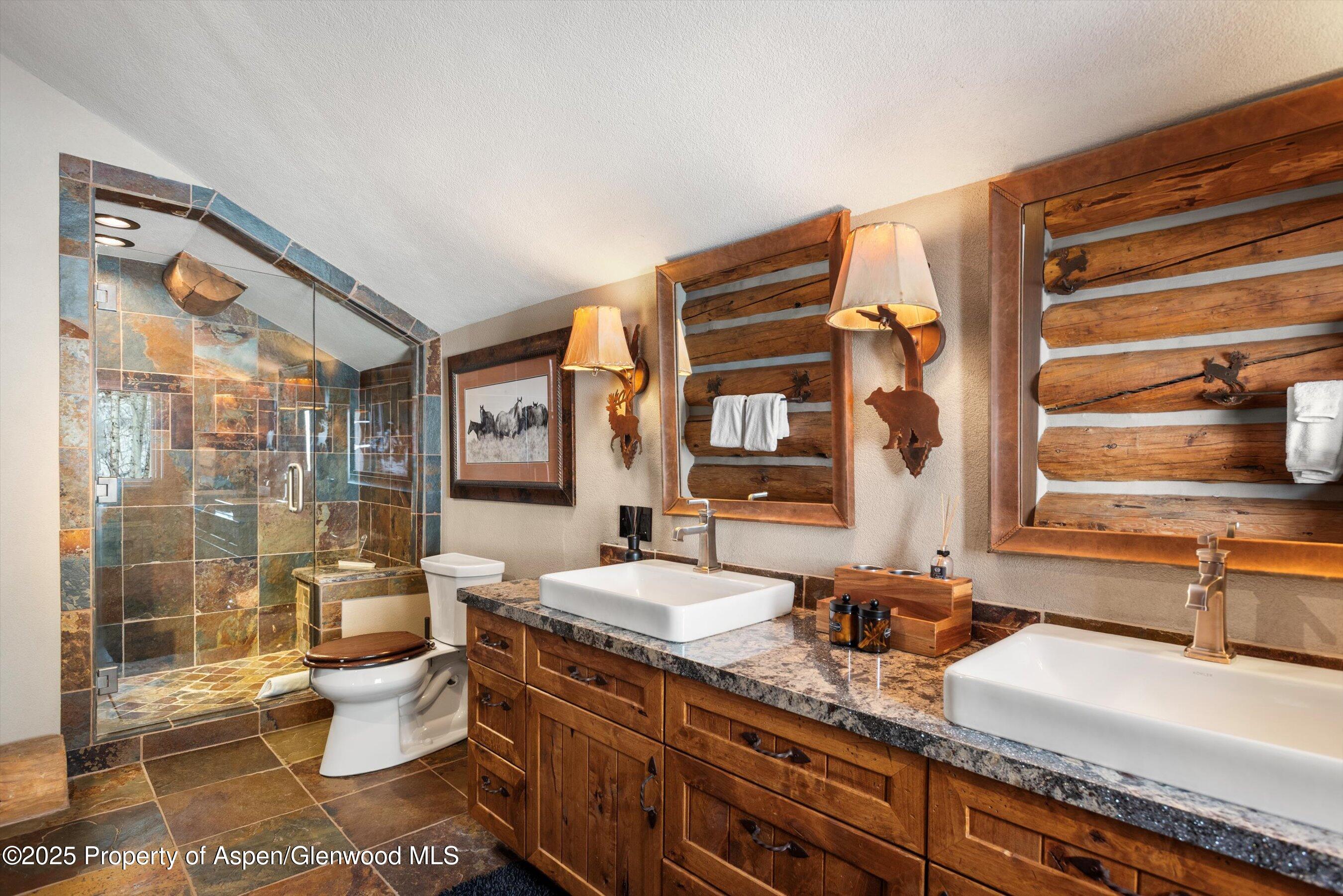303 Conundrum Creek Road Aspen, CO 81611 - Photo 24 of 39 a bathroom with a granite countertop sink mirror vanity and toilet