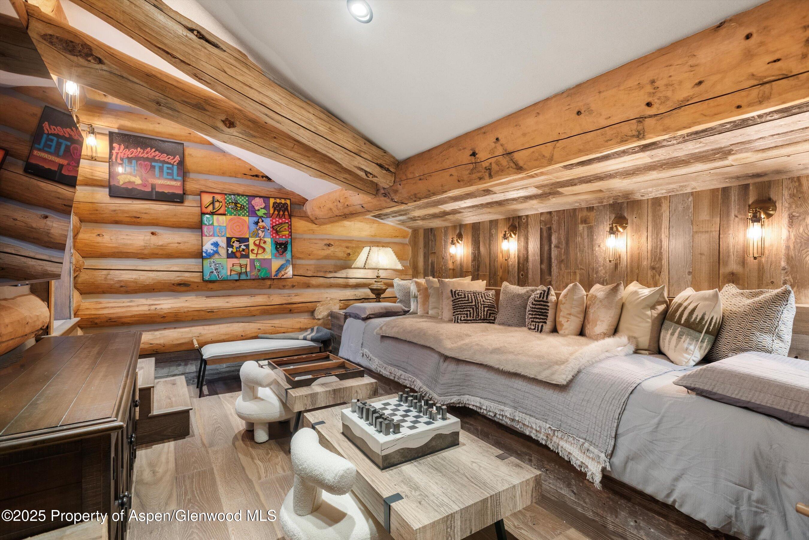 303 Conundrum Creek Road Aspen, CO 81611 - Photo 25 of 39 a living room with furniture and a chandelier