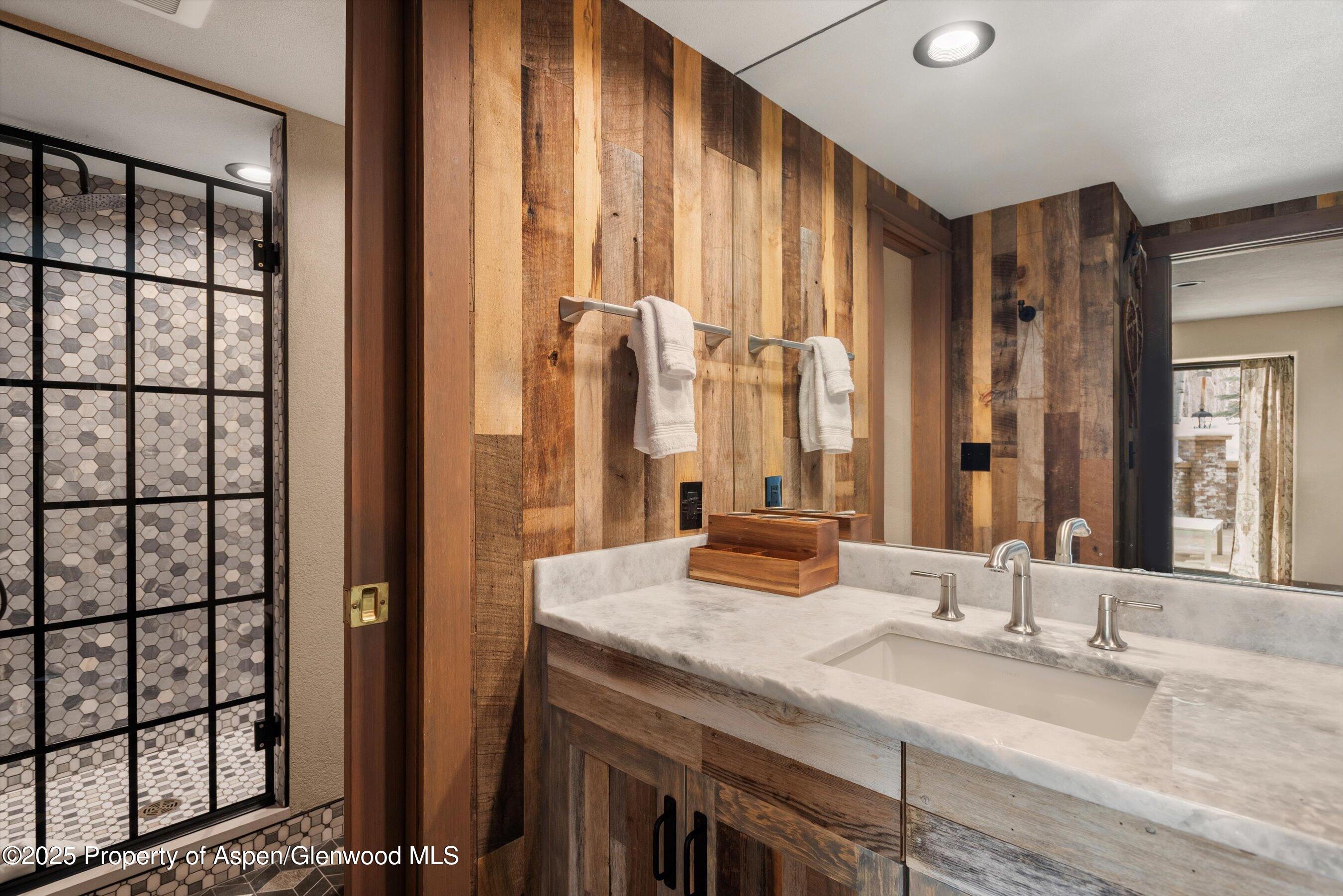 303 Conundrum Creek Road Aspen, CO 81611 - Photo 27 of 39 a bathroom with a granite countertop sink and a large mirror