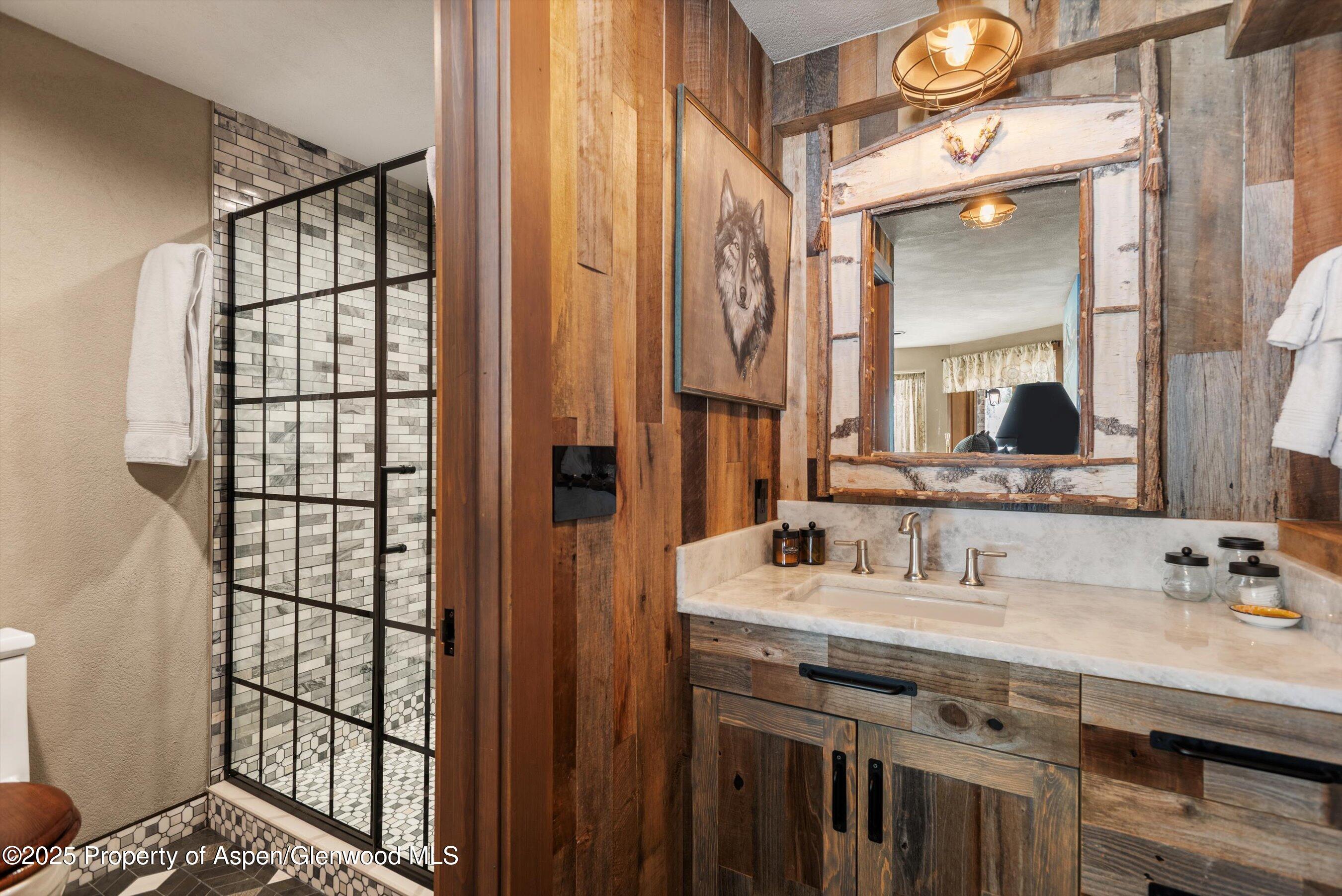 303 Conundrum Creek Road Aspen, CO 81611 - Photo 29 of 39 a bathroom with a double vanity sink and mirror