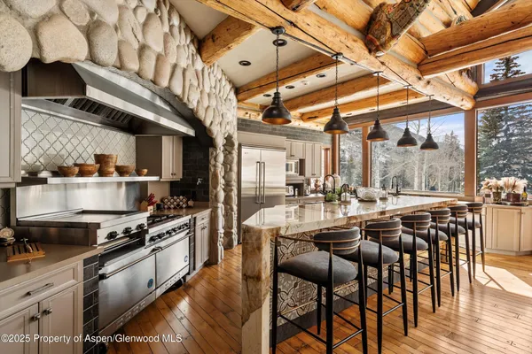a large kitchen with a table and chairs