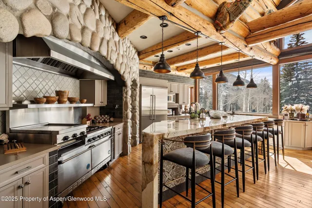a large kitchen with a table and chairs