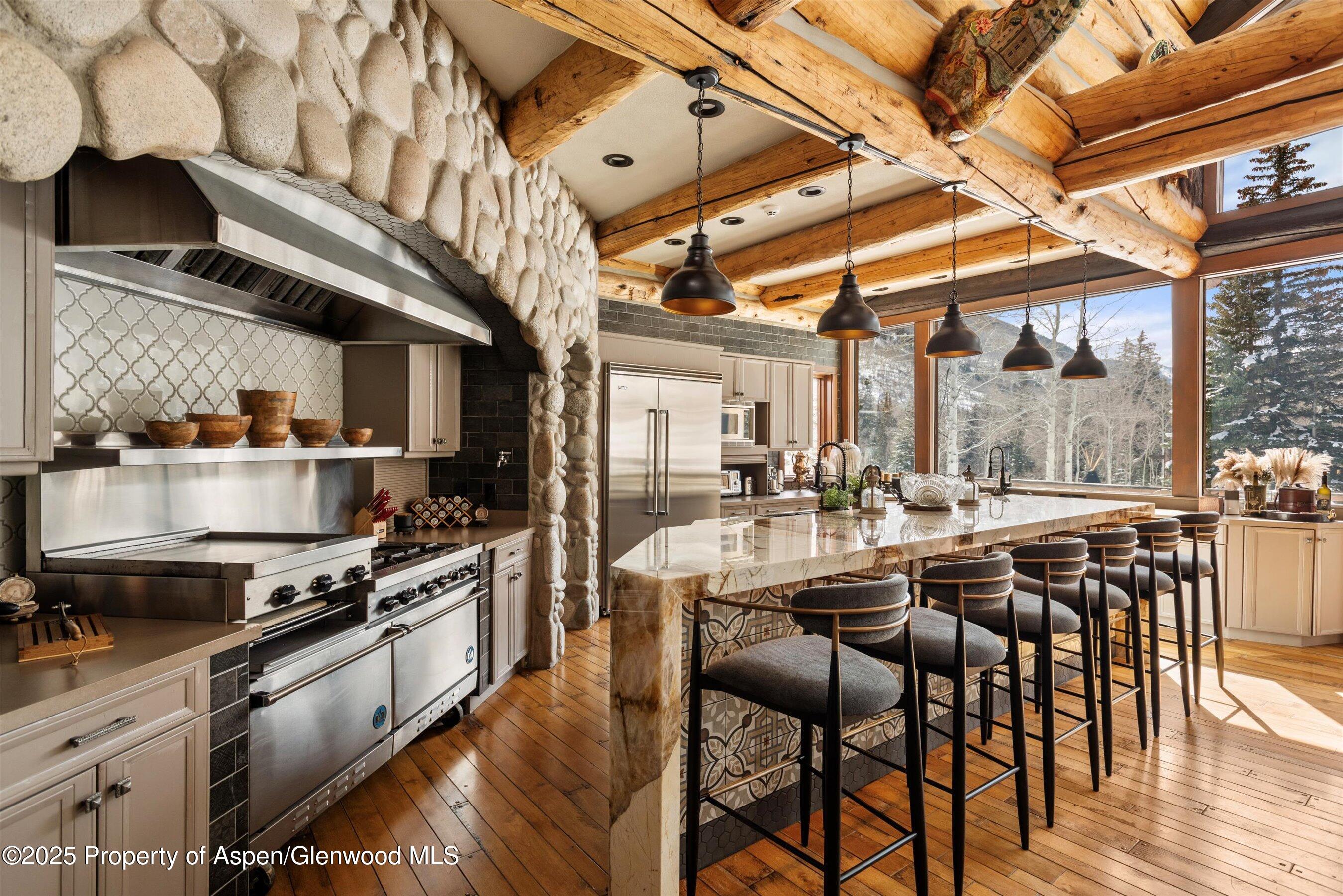 303 Conundrum Creek Road Aspen, CO 81611 - Photo 3 of 39 a large kitchen with a table and chairs