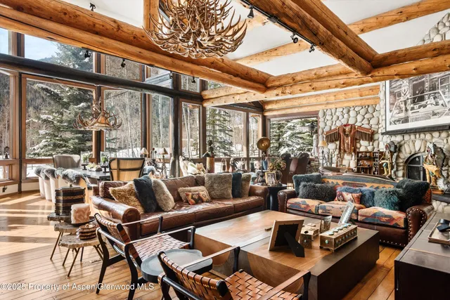 a living room with furniture a rug floor and a large window