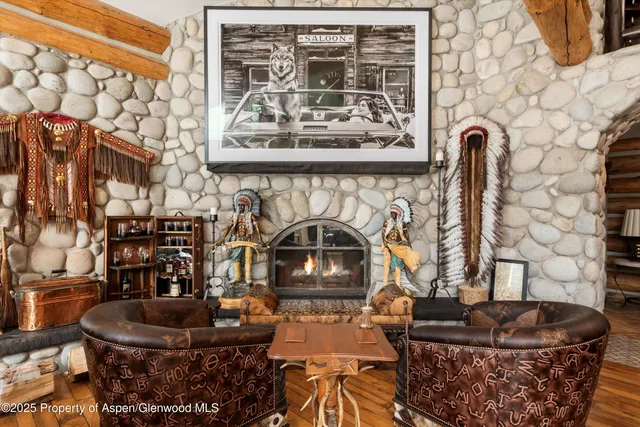 a living room with furniture a fireplace and a large window