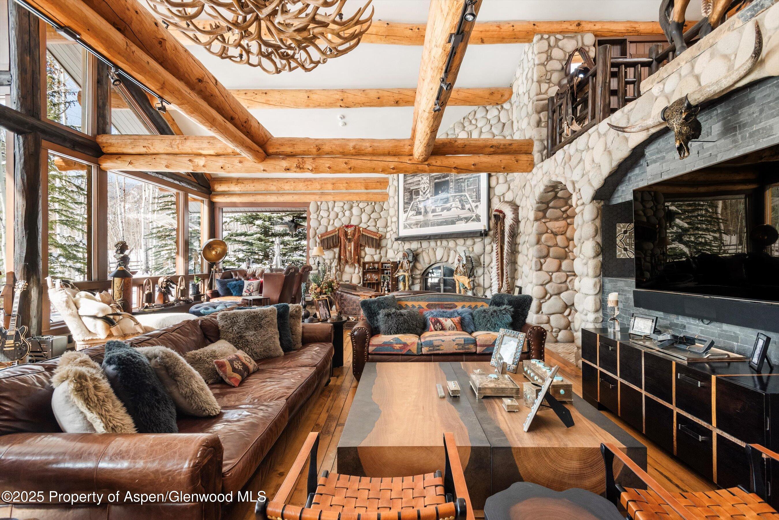303 Conundrum Creek Road Aspen, CO 81611 - Photo 10 of 39 a living room with furniture a rug floor and a large window