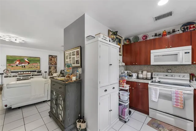 a kitchen with a stove top oven and cabinets
