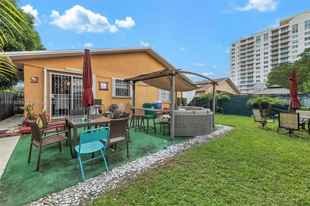 a view of a patio with table and chairs and potted plants