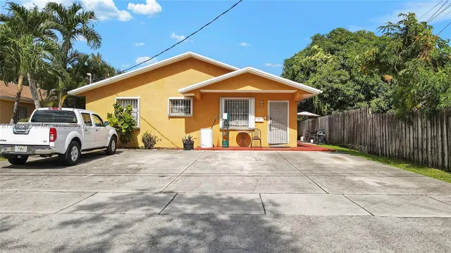 a view of a house with a yard and garage
