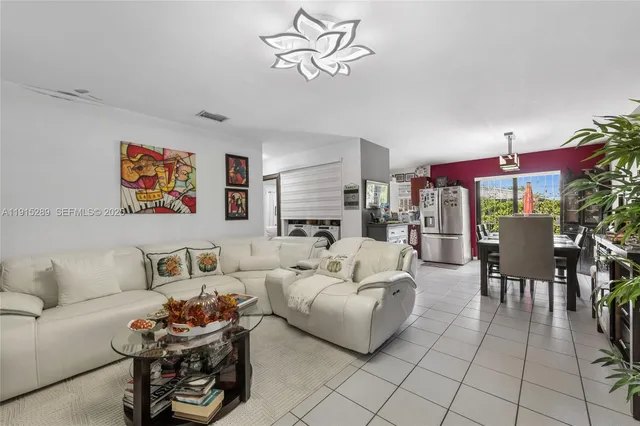 a living room with furniture and a potted plant