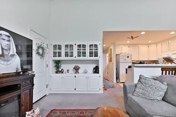 a living room with furniture and kitchen view