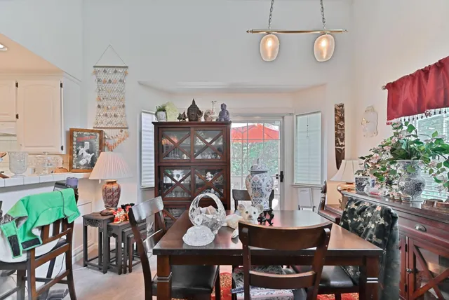 a view of a dining room with furniture and chandelier