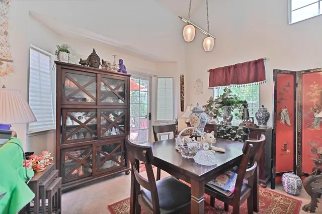 a view of a dining room with furniture and a window