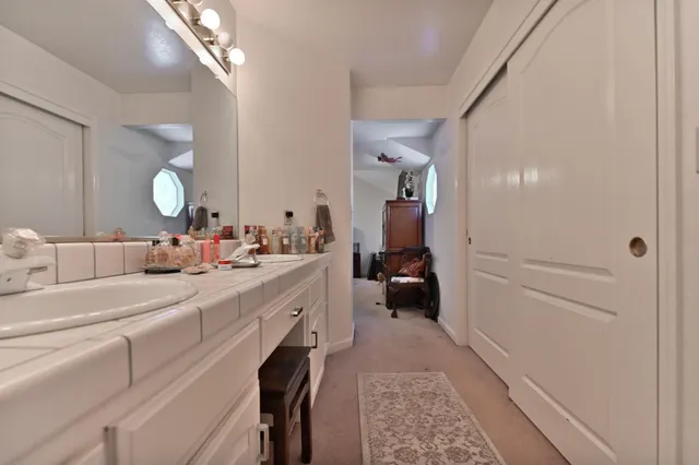 a en suite bathroom with a double vanity sink and a mirror