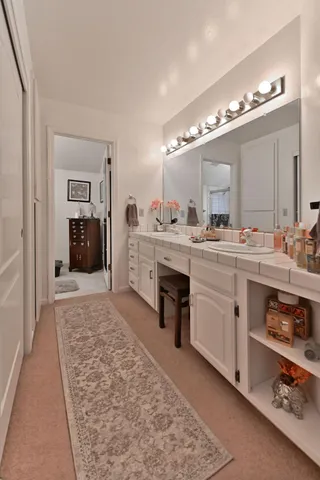 a large bathroom with a double vanity sink and a mirror