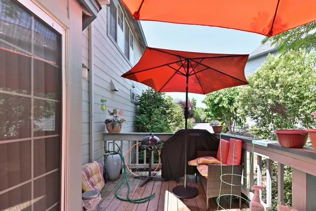 a patio with a table and chairs under an umbrella