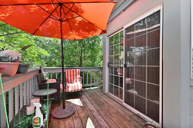 a view of balcony with wooden floor and outdoor seating