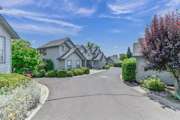 a front view of a house with a yard and a garage