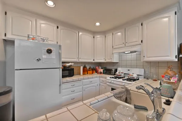 a white refrigerator freezer sitting in a kitchen
