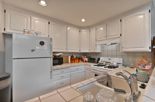 a white refrigerator freezer sitting in a kitchen