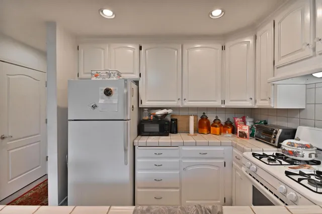 a kitchen with stainless steel appliances a refrigerator sink and cabinets