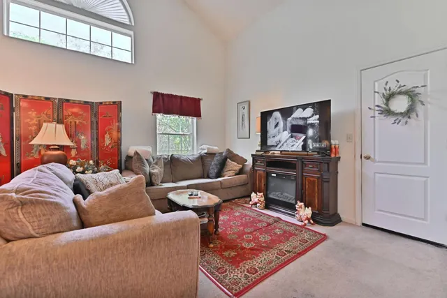 a living room with furniture a rug and a window