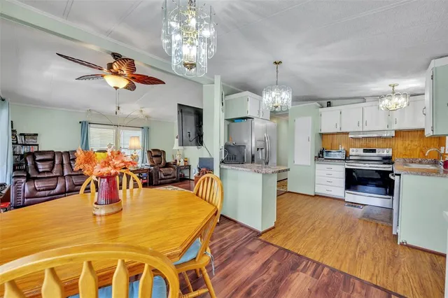 a view of a dining room with furniture and chandelier