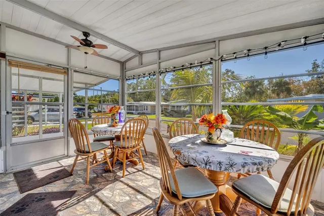 a bedroom with a bed lamps and a large mirror on the dresser