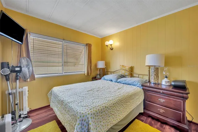 a bed room with a bed and a chair