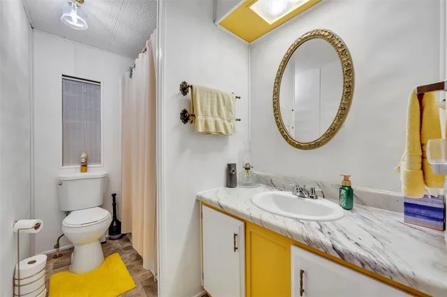 a bedroom with a bed and a flat tv screen on wall