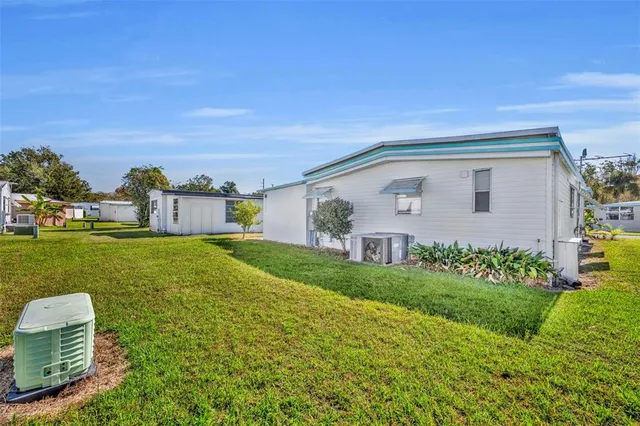 an aerial view of residential houses with yard