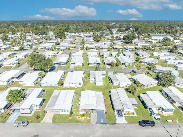 an aerial view of residential houses with yard
