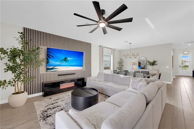 a living room with furniture a table and a potted plant