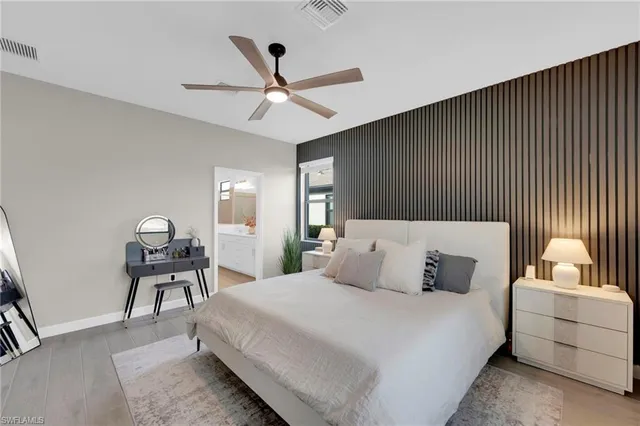 a bedroom with a large bed and a flat screen tv