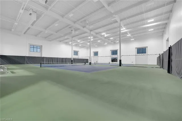 a large room with lots of counter space and windows