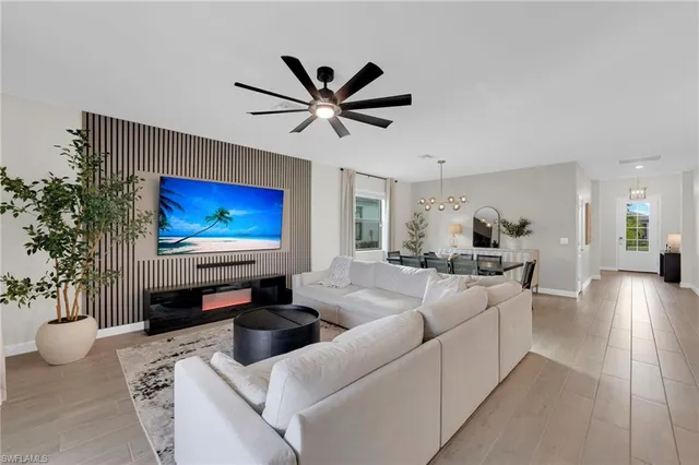 a dining room with furniture a chandelier and window