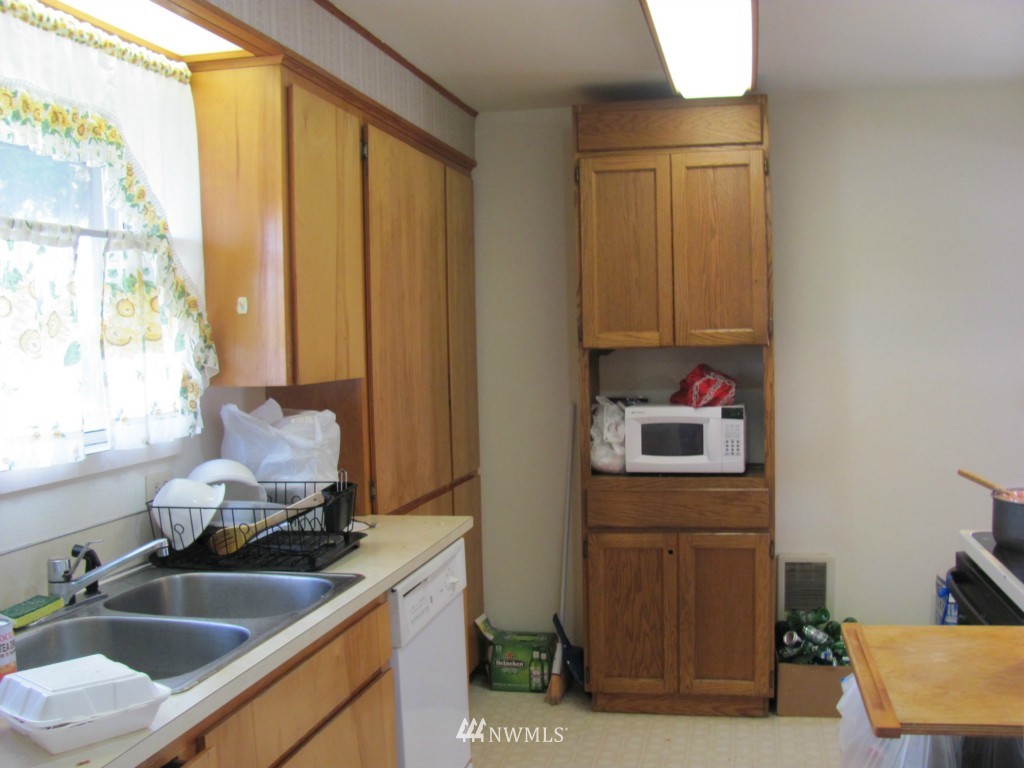 10804 Davisson Road Southwest Lakewood, WA 98499 - Photo 2 of 15 a kitchen with a sink and a refrigerator