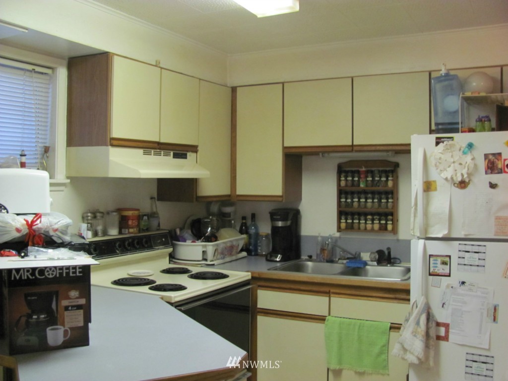 10804 Davisson Road Southwest Lakewood, WA 98499 - Photo 13 of 15 a kitchen with a sink stove and cabinets
