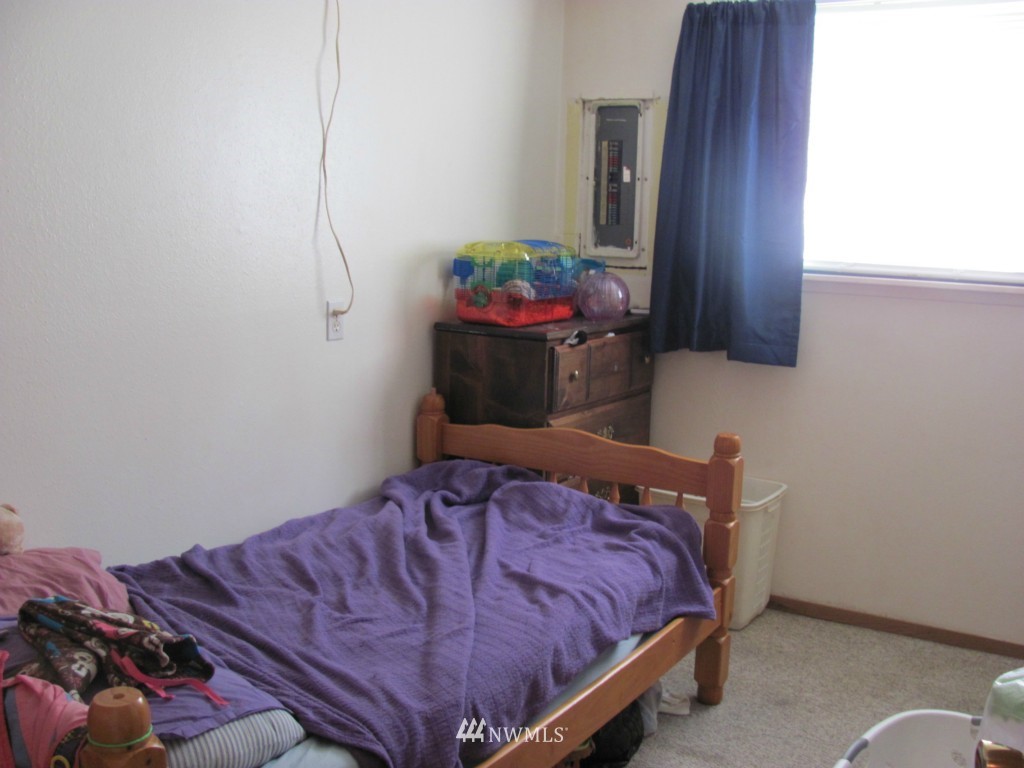 10804 Davisson Road Southwest Lakewood, WA 98499 - Photo 15 of 15 a bed sitting in a bedroom next to a window