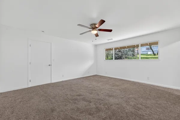 a view of a big room with carpet