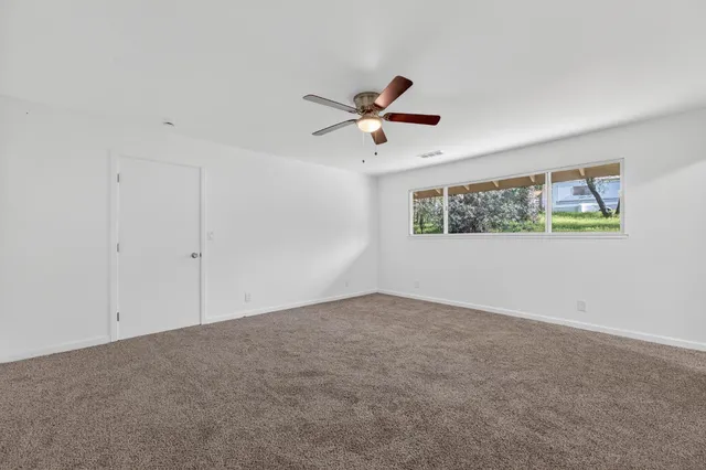 a view of a big room with carpet