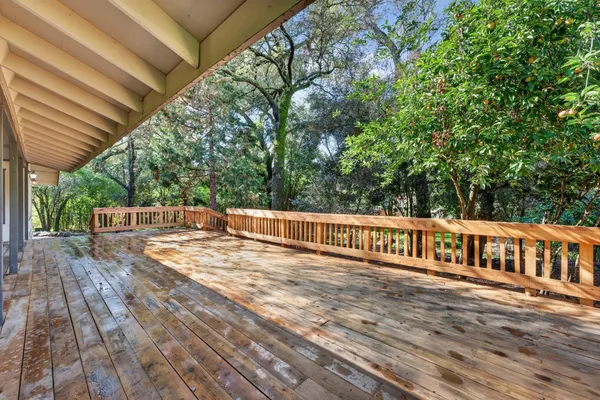 a view of a house with wooden deck