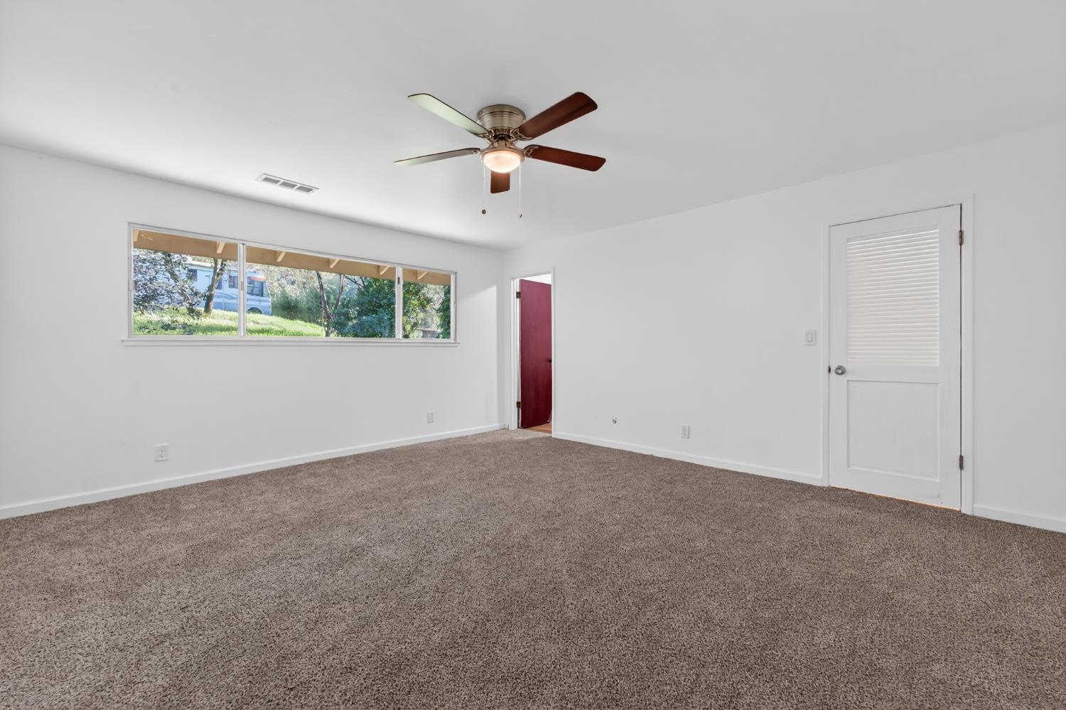 8040 Gilardi Road Newcastle, CA 95658 - Photo 10 of 23 a view of a livingroom with a ceiling fan and window