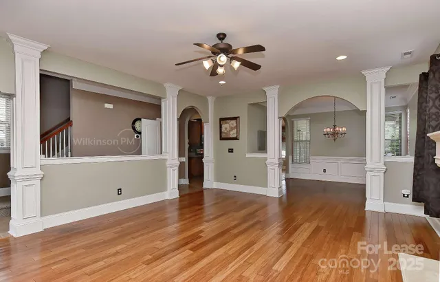 a view of a living room and bathroom with wooden floor