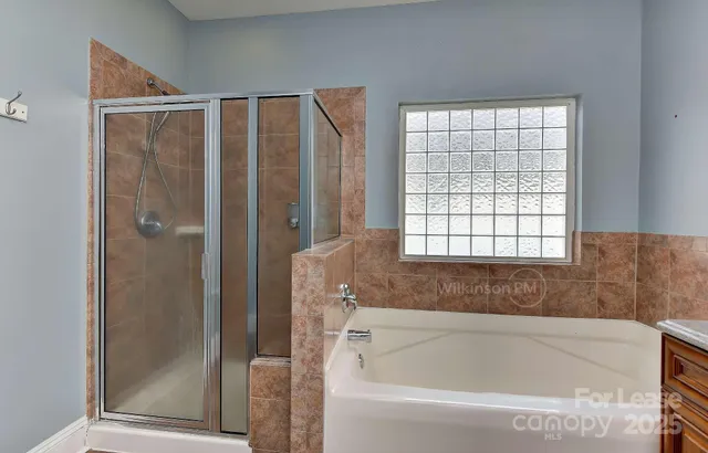 a bathroom with a bathtub and a shower