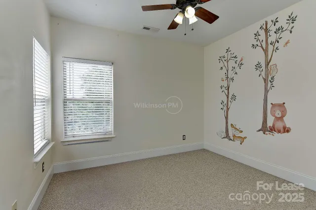 a view of a livingroom with a ceiling fan and window