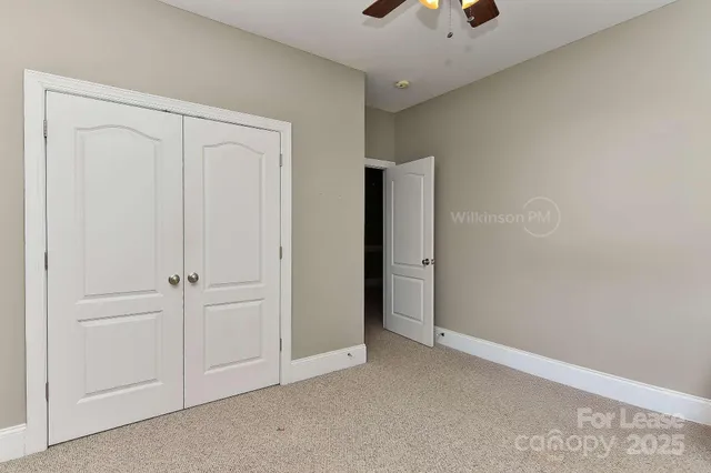 a bathroom with a granite countertop bathtub shower sink vanity and toilet
