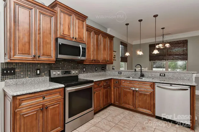 a kitchen with a sink stove and microwave